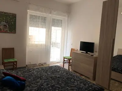 a bedroom with a bed and a tv on a dresser at Casa Salù in Rome
