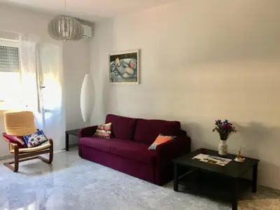 a living room with a purple couch and a table at Casa Salù in Rome