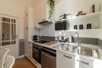 a kitchen with a sink and a stove at Castro Pretorio 24 - FromHometoRome in Rome