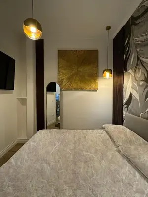 a bedroom with a bed and two pendant lights at Heart Of Rome Luxe Suite in Rome