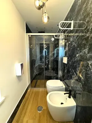 a bathroom with a white sink and a toilet at Heart Of Rome Luxe Suite in Rome