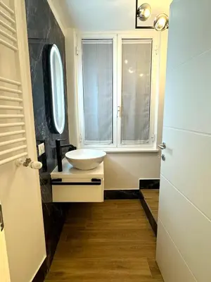 a bathroom with a sink and a window at Heart Of Rome Luxe Suite in Rome