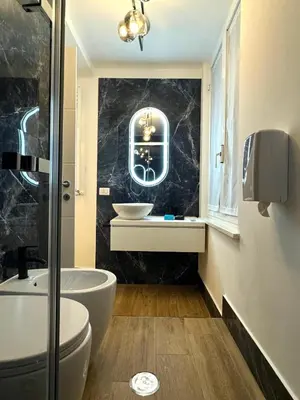 a bathroom with a sink and a toilet and a tub at Heart Of Rome Luxe Suite in Rome