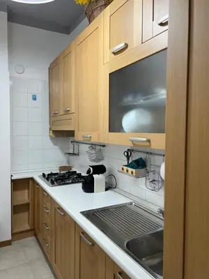 a kitchen with wooden cabinets and a stove top oven at Serendiroma in Rome