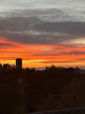 a sunset over a city with the sky at Serendiroma in Rome