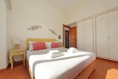 a bedroom with a large bed with towels on it at Piazza di Spagna Cozy House & Amazing View in Rome