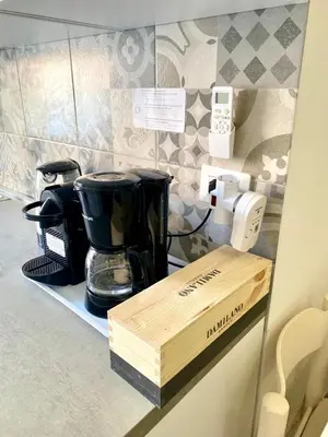a kitchen counter with a coffee maker on a counter top at Vacanze Romane at Furio Camillo in Rome