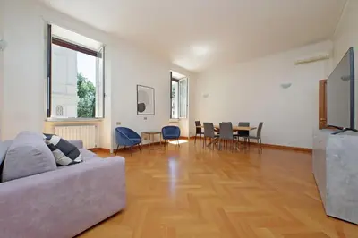 a living room with a couch and a table and chairs at Luxury home in the Ghetto's heart in Rome