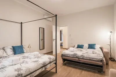 a bedroom with two beds and a mirror at C3 Top Class Apartment, 2 camere da letto, 2 bagni, giardino distante 15 minuti a piedi da Fontana di Trevi in Rome