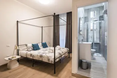 a bedroom with a canopy bed and a bathroom at C3 Top Class Apartment, 2 camere da letto, 2 bagni, giardino distante 15 minuti a piedi da Fontana di Trevi in Rome