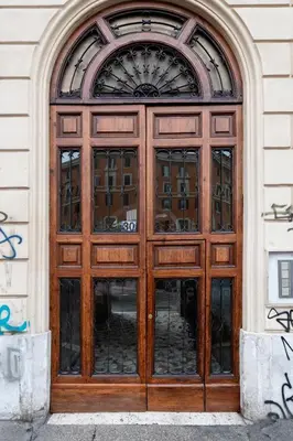 a large wooden door on a building at White Flat Sanniti in Rome