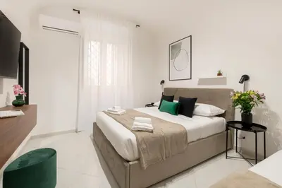 a bedroom with a large bed with green pillows at White Flat Sanniti in Rome