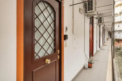 a brown door on a building with a sidewalk at White Flat Sanniti in Rome