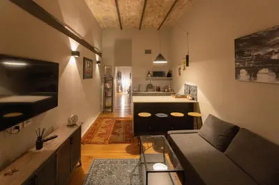 a living room with a couch and a kitchen at Trastevere Spot in Rome