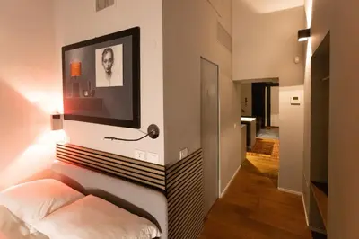 a hallway with a bed and a picture on the wall at Trastevere Spot in Rome