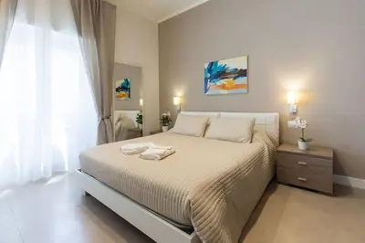 a bedroom with a bed with two towels on it at Maison Romana in Rome