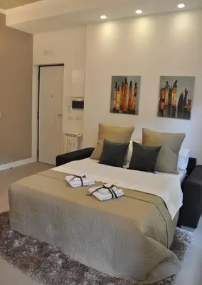 a bedroom with a large bed with glasses on it at Maison Romana in Rome