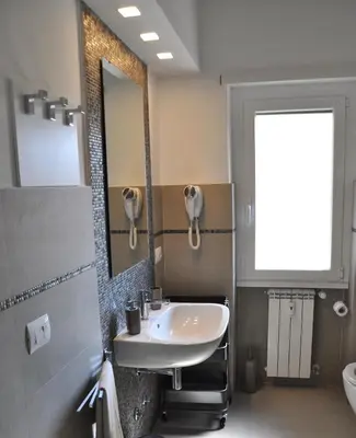 a bathroom with a sink and a mirror at Maison Romana in Rome