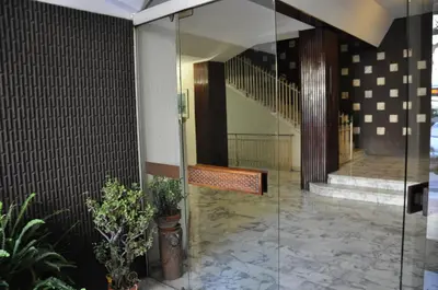 a lobby with a bench and a staircase with plants at Maison Romana in Rome