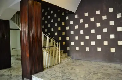 a staircase in a building with a checkerboard wall at Maison Romana in Rome
