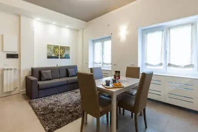 a living room with a table and a couch at Maison Romana in Rome
