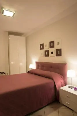 a bedroom with a bed and some pictures on the wall at Termini in Bed in Rome