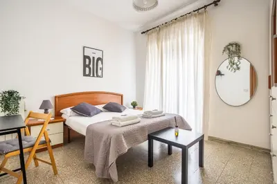 a bedroom with a bed and a table and a mirror at Espress break in Rome