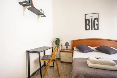 a bedroom with a bed and a desk and a chair at Espress break in Rome