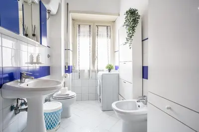 a white bathroom with a sink and a toilet at Espress break in Rome