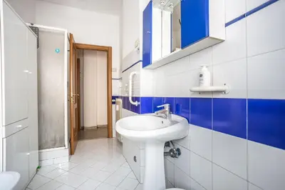 a bathroom with a sink and blue and white tiles at Espress break in Rome
