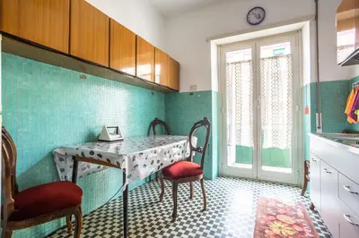 a kitchen with a table and chairs in a room at Espress break in Rome