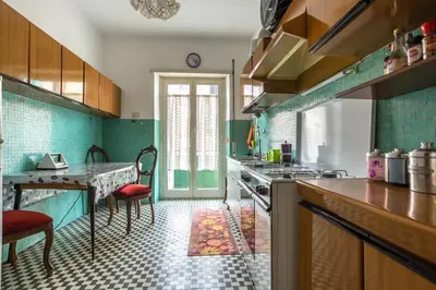 a kitchen with a counter and a table in it at Espress break in Rome