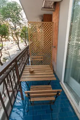 a porch with two benches on a balcony at Magna Cura in Rome