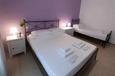 a bedroom with two beds with towels on them at Magna Cura in Rome