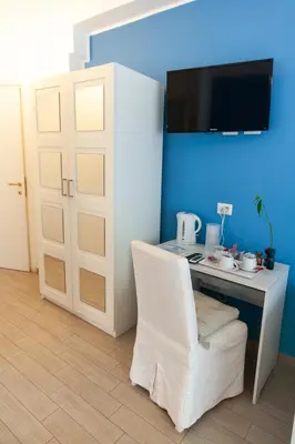 a room with a white desk and a white chair at Magna Cura in Rome