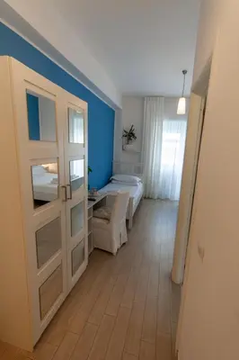 a room with a bedroom with a bed and a door at Magna Cura in Rome