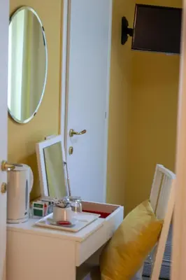 a bathroom with a vanity with a mirror and a sink at Magna Cura in Rome