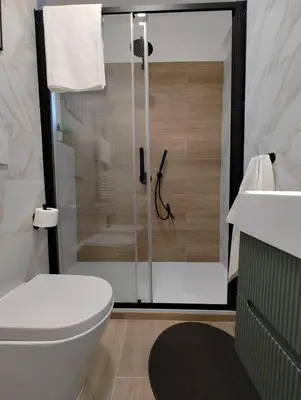a bathroom with a shower with a toilet and a sink at A casa di nonna Lina - Apartment in Ostiense in Rome