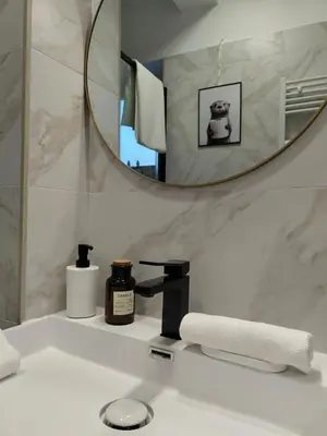 a bathroom with a sink with a mirror and a towel at A casa di nonna Lina - Apartment in Ostiense in Rome