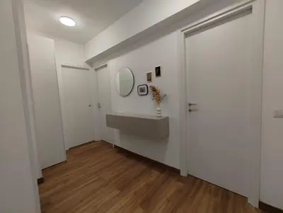 a white bathroom with a sink and a mirror at A casa di nonna Lina - Apartment in Ostiense in Rome