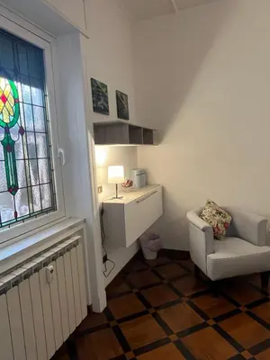 a living room with a chair and a window at HOUSE BOCCEA Rome in Rome