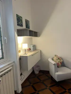 a room with a desk and a chair and a lamp at HOUSE BOCCEA Rome in Rome