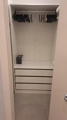 a walk in closet with white cabinets and hangers at Casa Gabri in Rome