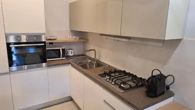 a kitchen with a stove top oven next to a microwave at Casa Gabri in Rome