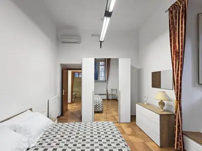 a bedroom with a bed with a checkeredkered floor at Comfort House Coppedé in Rome