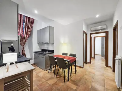 a kitchen and dining room with a table and chairs at Comfort House Coppedé in Rome