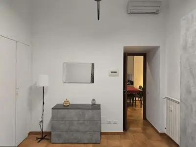 a white room with a table and a lamp at Comfort House Coppedé in Rome
