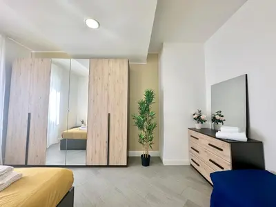 a bedroom with a mirror and a bed and a dresser at Sergio I Apartment in Rome