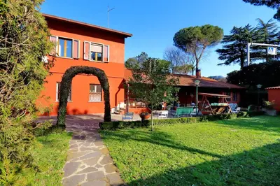 an orange house with an arch in a yard at Antico Platano in Rome