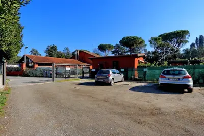 two cars parked in a parking lot in front of a house at Antico Platano in Rome